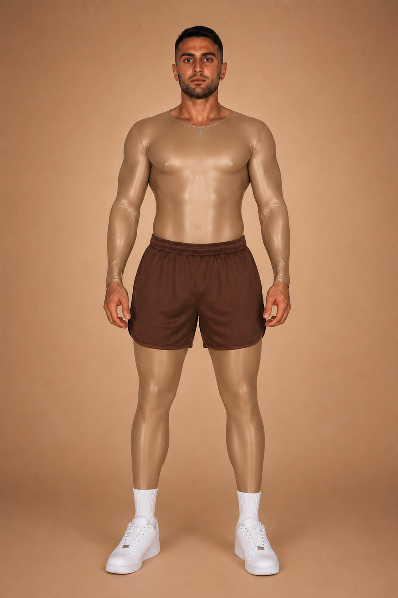 the second skin — tan full-body suit worn under brown gym shorts, front view against warm sand backdrop