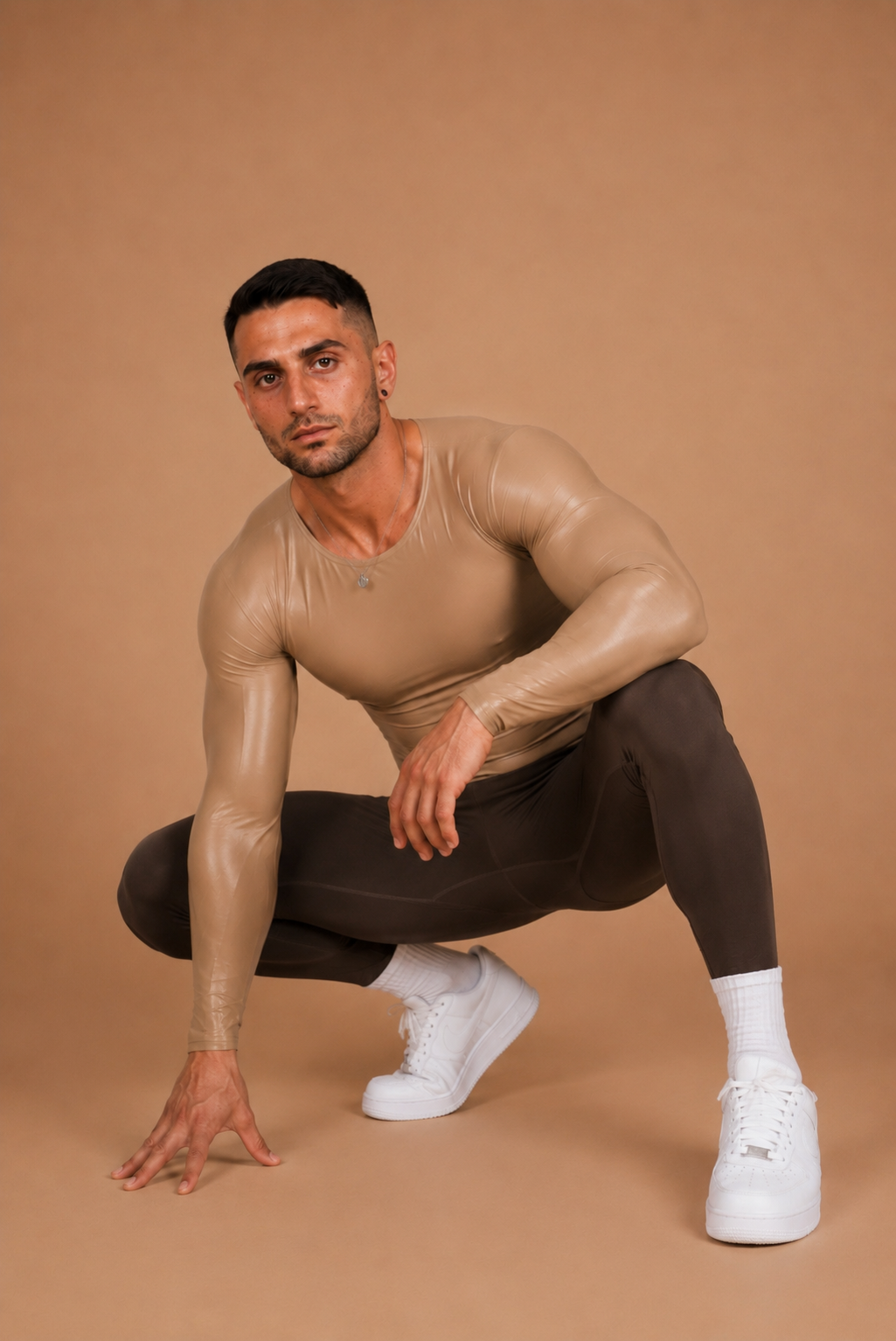 the scrunch legging — crouched pose styled with the second skin top, warm sand backdrop